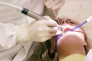 Dentist performing oral surgery.