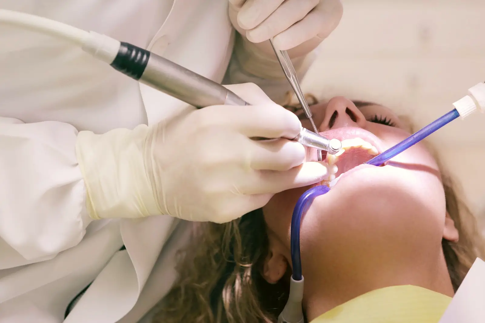 Dentist performing oral surgery.