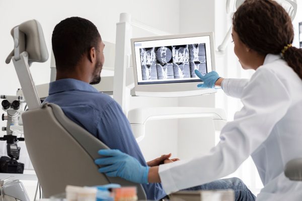 dentist showing patient their x-rays