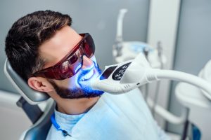 man getting a professional teeth whitening treatment
