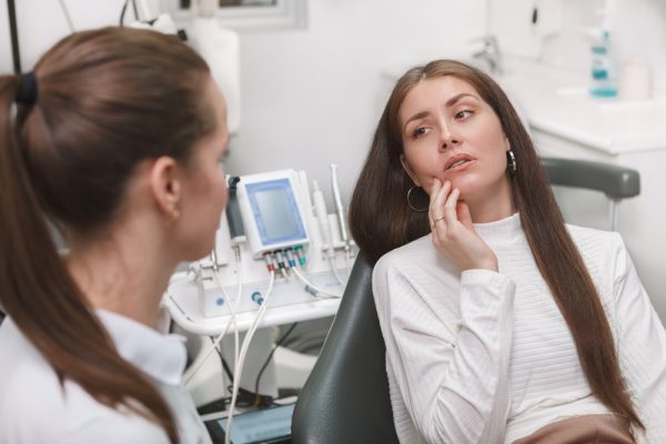 Young woman getting dental sealants at the dentist